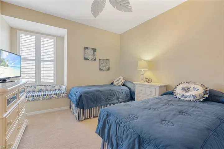 Bedroom with light colored carpet and ceiling fan