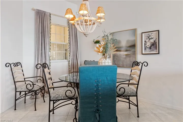 Tiled dining space featuring an inviting chandelier