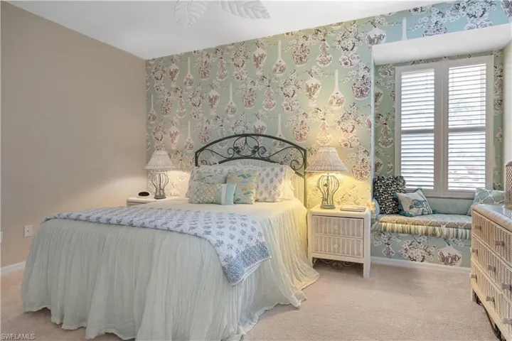 Bedroom featuring carpet flooring and multiple windows