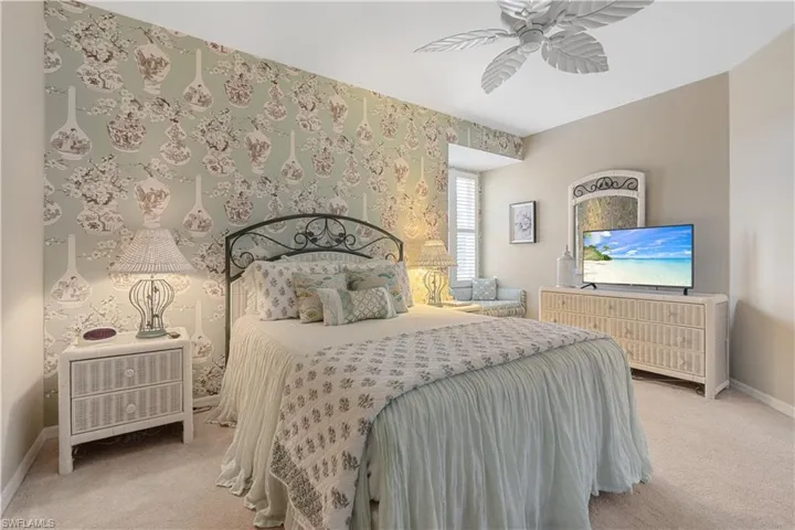 Bedroom with light carpet and ceiling fan