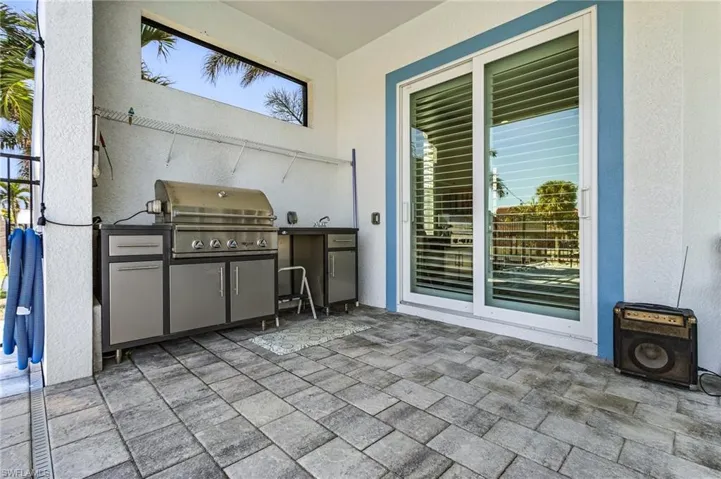 Outdoor Kitchen and sliders to Primary Bedroom.