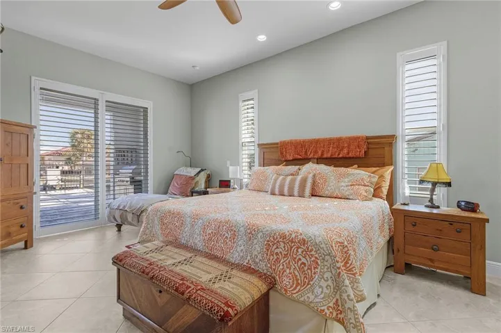 Primary bedroom has sliders leading to pool lanai and outdoor kitchen.
