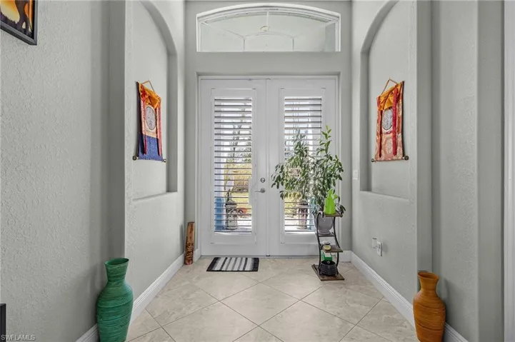 French Door entry to the home with Plantation Shutters & Niches.