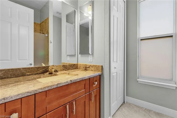 Guest Bath has cherry cabinets and granite.