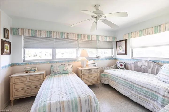Bedroom featuring multiple windows, extra large closet and ceiling fan
