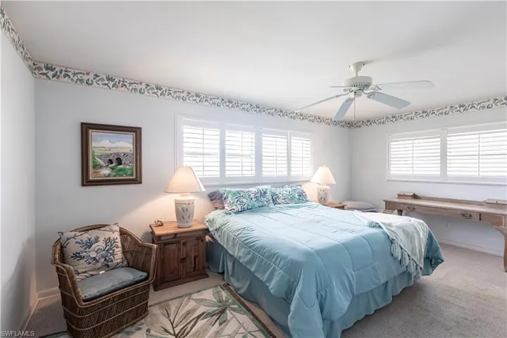 Spacious Main bedroom with King Sized Bed and plenty of room, walk in closet, main bath with walk in shower and ceiling fan