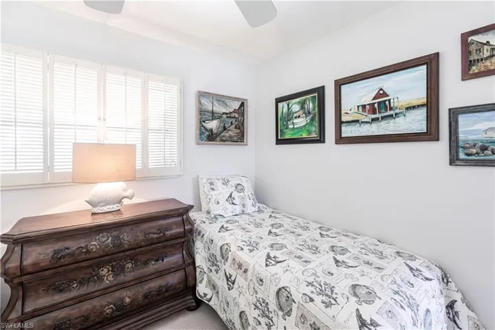 Bedroom featuring a ceiling fan and deep closet