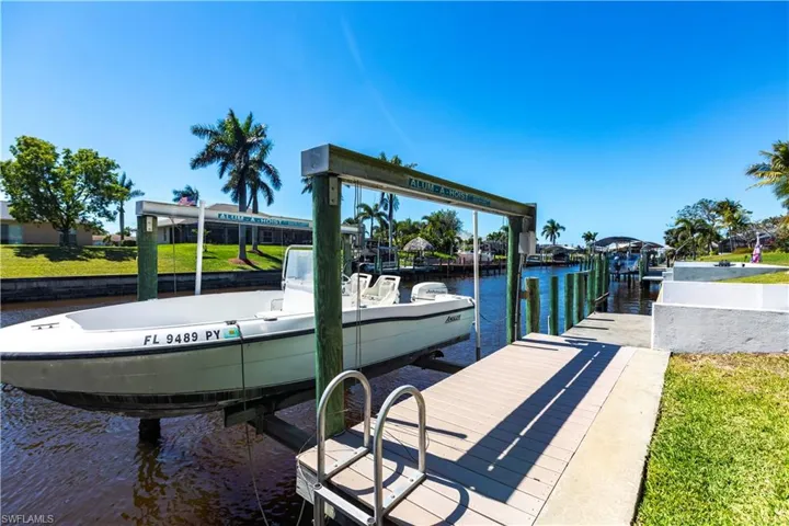 View of dock with a water view and boat lift