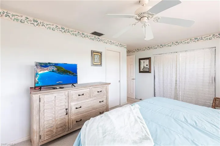Main Bedroom with walk in closet, baseboards, and a ceiling fan. Walk out to Sunroom. Master shower is walk in shower