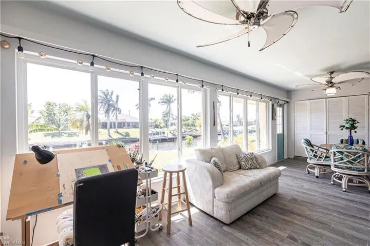 Sun room featuring a ceiling fan and wood finished floors. Stunning Views