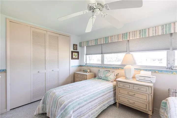 large Bedroom with a deep closet, and a ceiling fan
