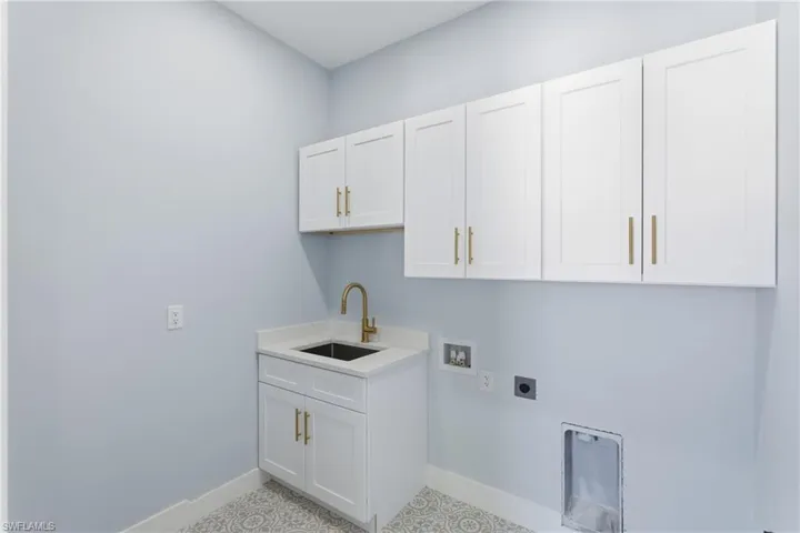 Laundry area with cabinet space, washer hookup, and hookup for an electric dryer