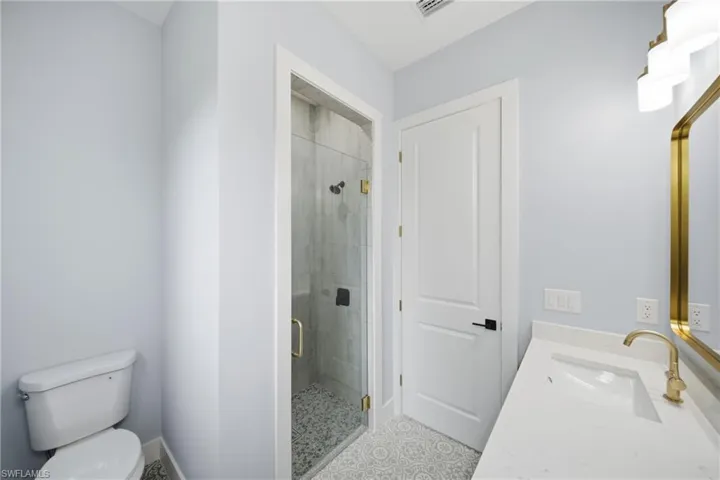 Bathroom with vanity and a shower stall