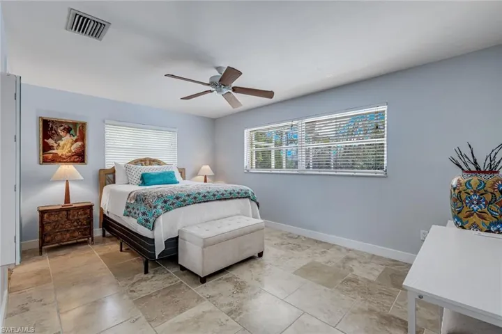 Primary suite offers pool and canal views.