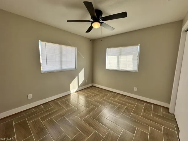 Unfurnished bedroom with a ceiling fan and parquet floors
