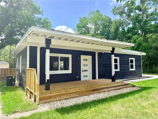 View of front of home with a wooden deck