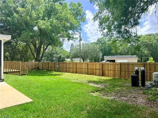 Fenced backyard with a deck