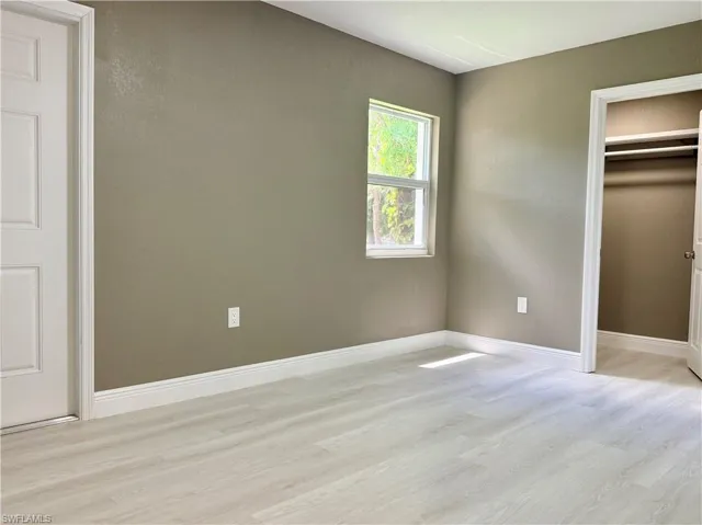 Unfurnished bedroom with a closet and light wood-style floors
