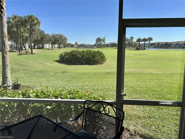 View of grassy yard with a water view
