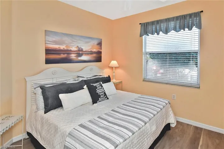 Bedroom with baseboards and wood finished floors