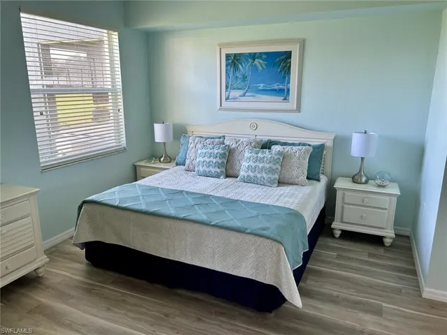 Bedroom featuring baseboards and wood finished floors