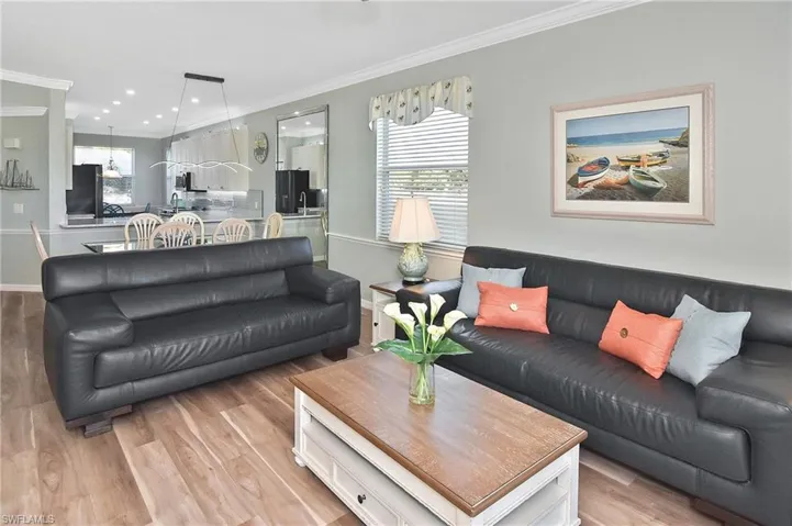 Living room featuring plenty of natural light, ornamental molding, light wood-style floors, and recessed lighting