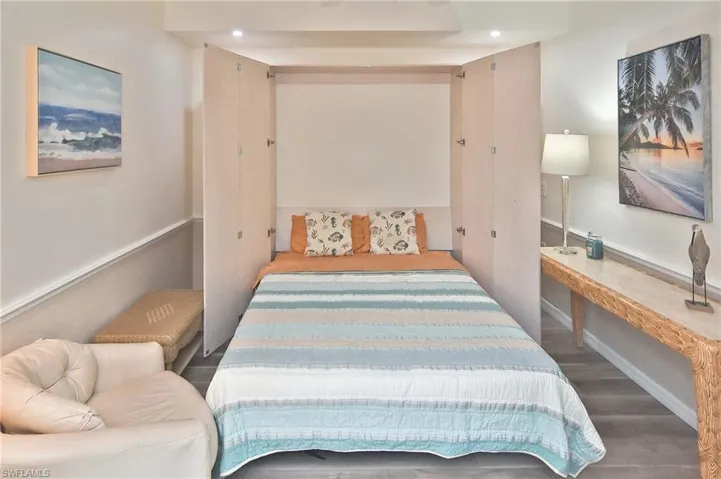 Bedroom with wood finished floors and recessed lighting