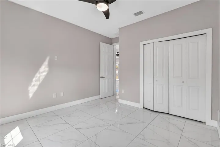 Unfurnished bedroom featuring a closet and ceiling fan