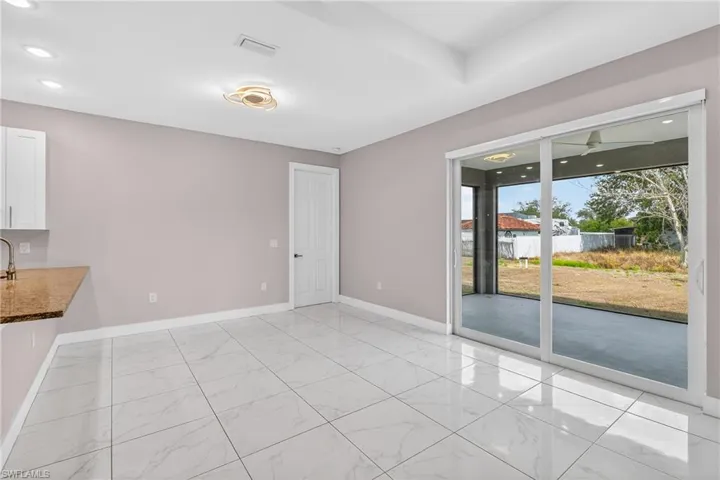Unfurnished dining area with recessed lighting and light marble finish floors