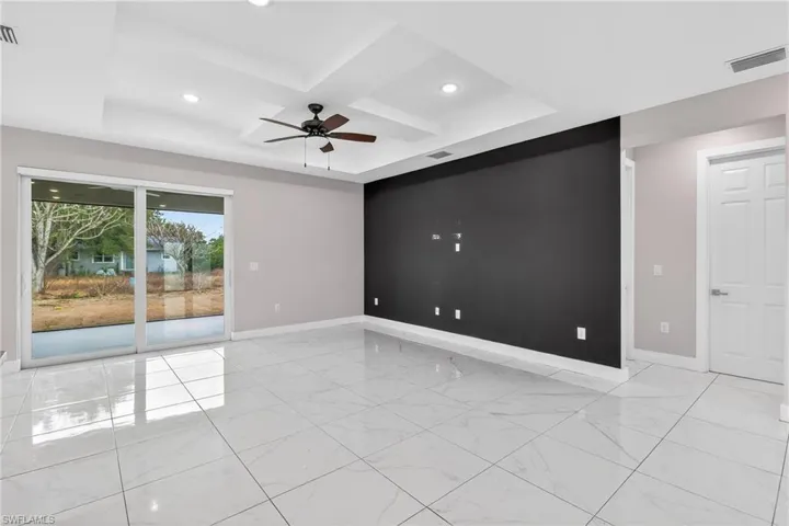Unfurnished room with coffered ceiling, ceiling fan, and recessed lighting