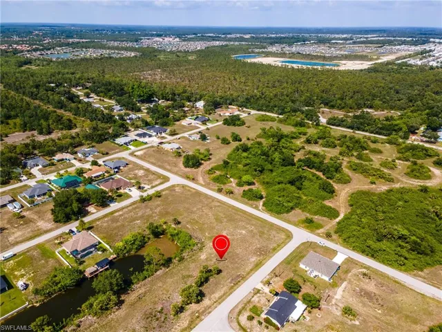 Aerial view of property and surrounding area featuring a large body of water
