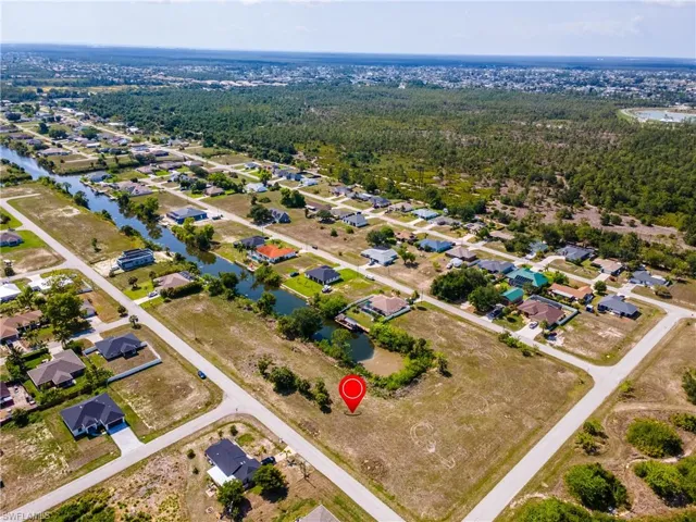 View of property location with a nearby body of water and nearby suburban area