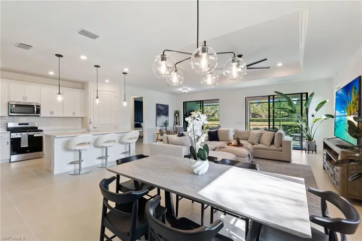 Dining room with recessed lighting, a chandelier, and light tile patterned floors