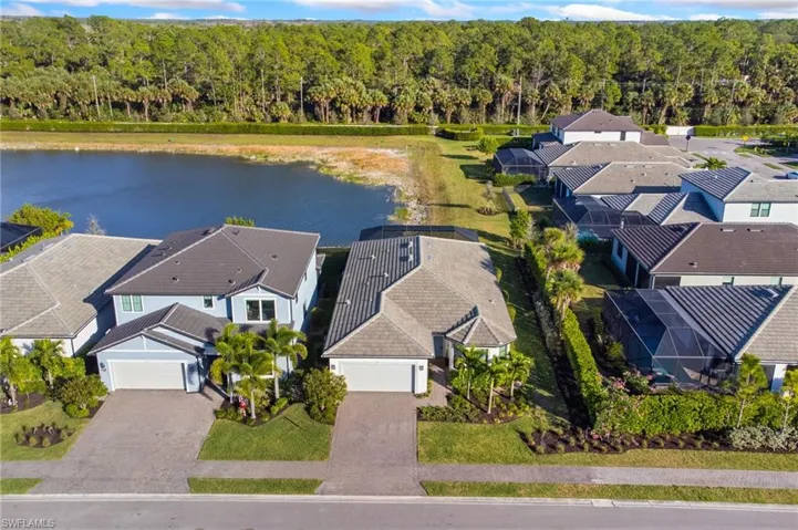 Aerial perspective of suburban area featuring a heavily wooded area
