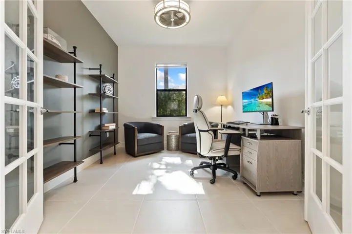 Home office featuring light tile patterned floors and french doors