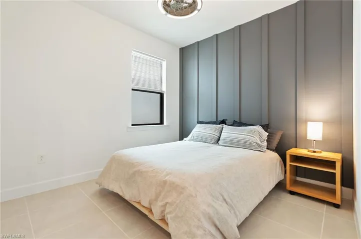 Bedroom with light tile patterned floors and baseboards