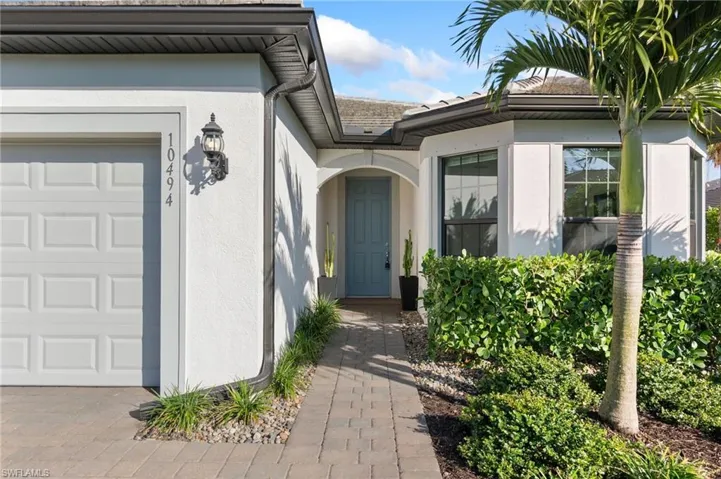 Entrance to property featuring stucco siding and a garage