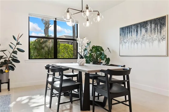 Dining room featuring a chandelier and light tile patterned floors
