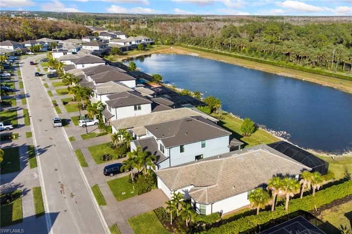Aerial view of residential area featuring a large body of water