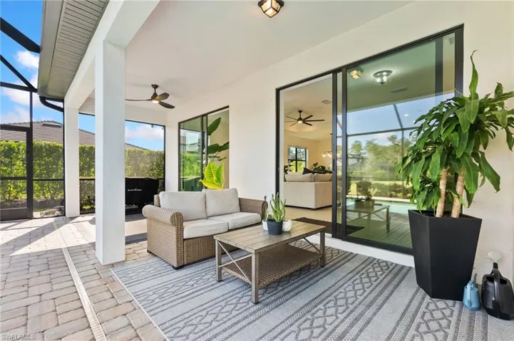 Sunroom with a patio area, a ceiling fan, and an outdoor hangout area