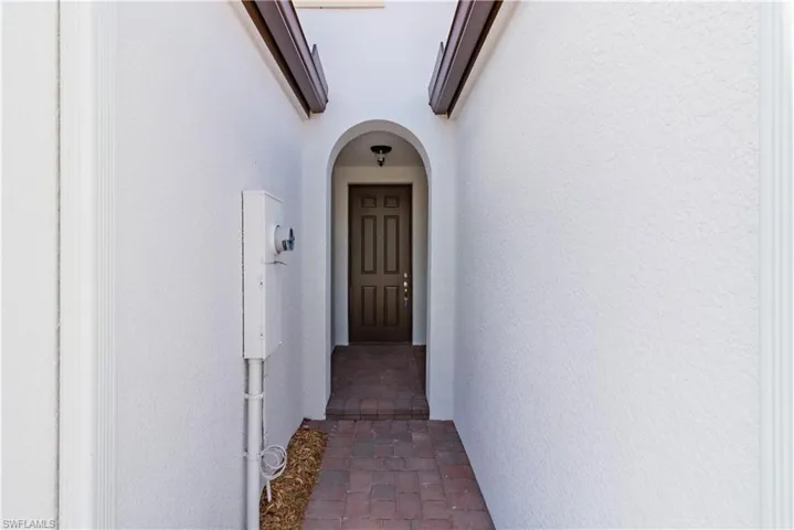 Doorway to property with a wall unit AC