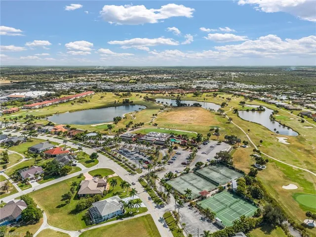 View of property location featuring a golf club and nearby suburban area