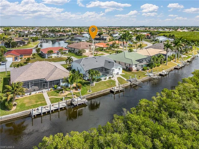 Aerial perspective of suburban area with a nearby body of water