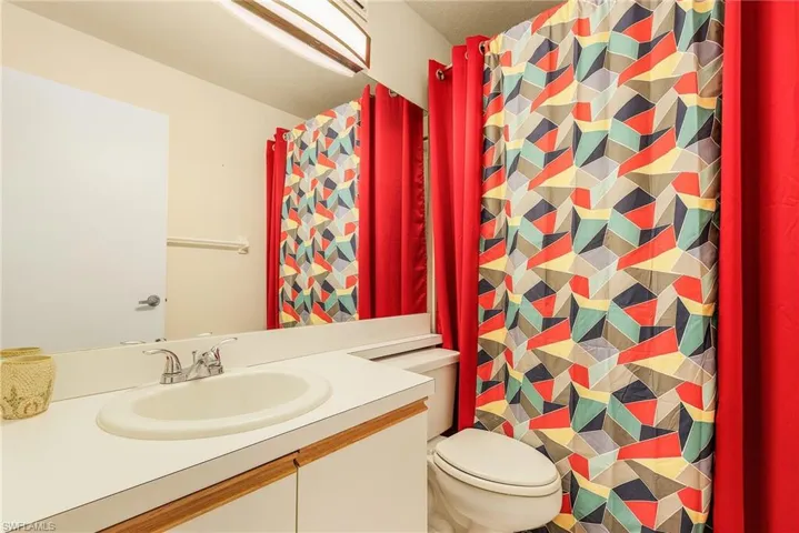 Full bathroom with vanity and a shower with curtain