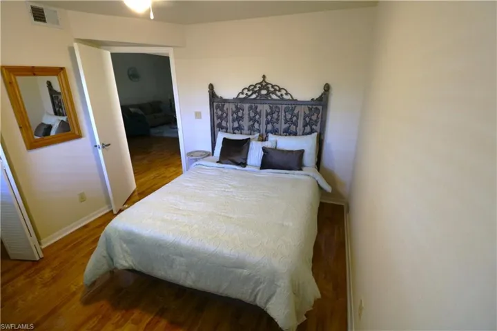 Bedroom featuring wood finished floors and baseboards
