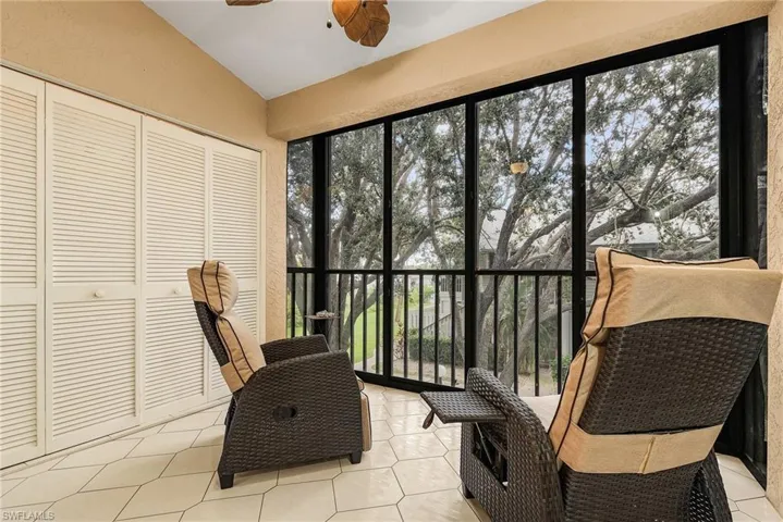 Sunroom / solarium with tile patterned flooring and lofted ceiling