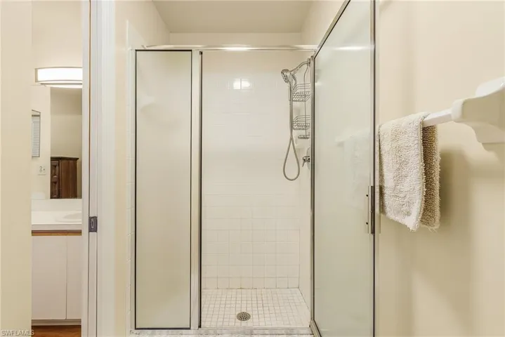 Full bath featuring a stall shower and vanity