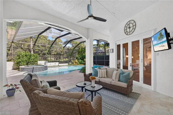 Outdoor lounge area overlooking the pool and golf course