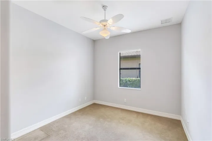 Spare room featuring ceiling fan and carpet flooring