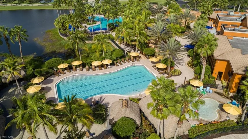 View of swimming pool with a patio and a water view